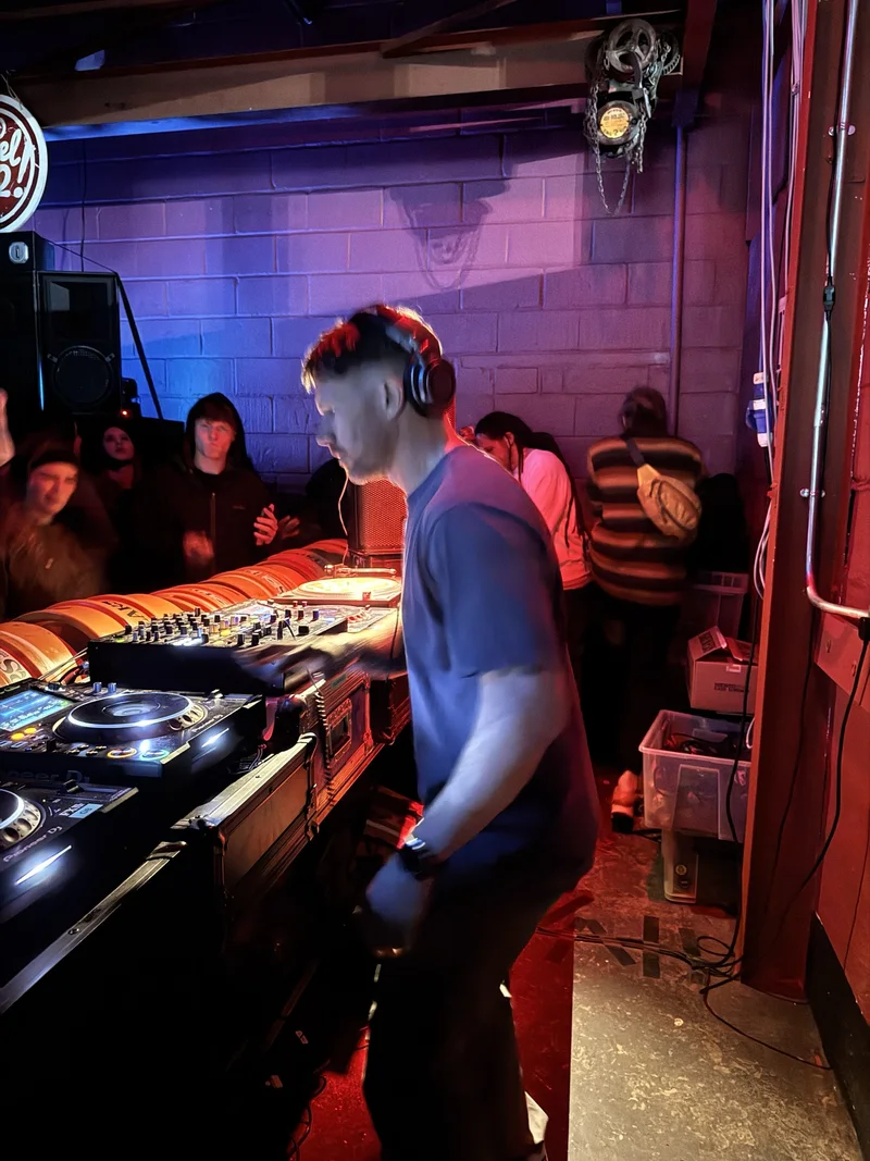 Bring The Beat Mack DJing on Pioneer decks with the crowd right behind the booth